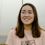 selective focus photograph of woman in pink crew-neck t-shirt